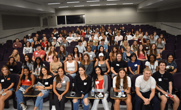 group of students seated in a large lecture hall