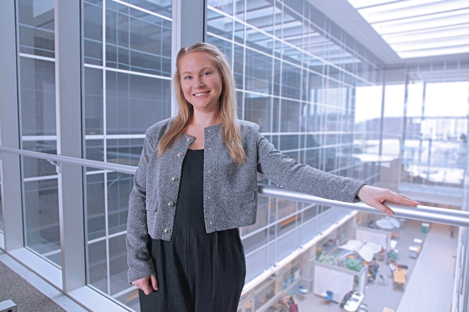 Skalski poses in front of a glass wall.