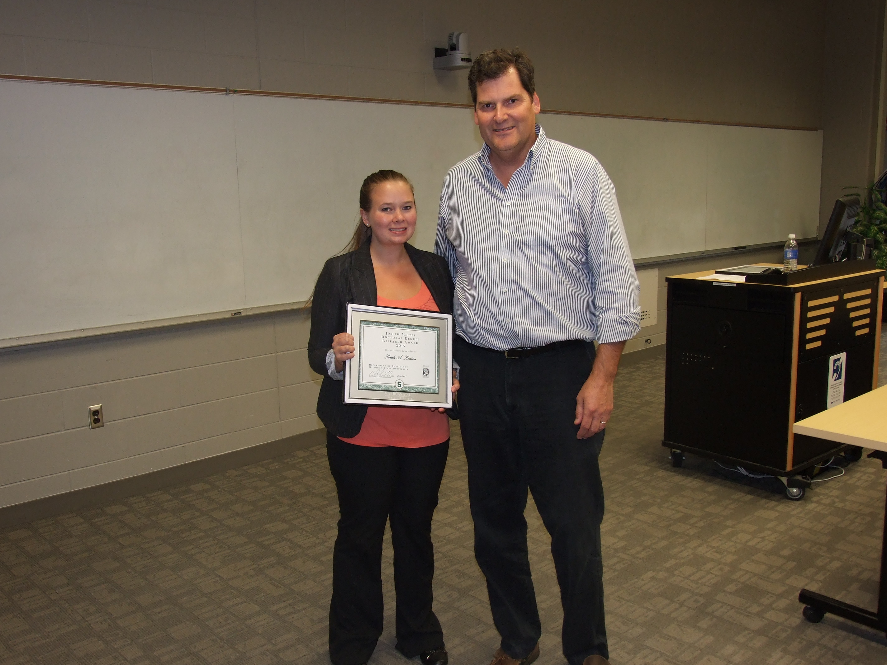 Sarah Keaton receiving an award from Dr. C. Lee Cox